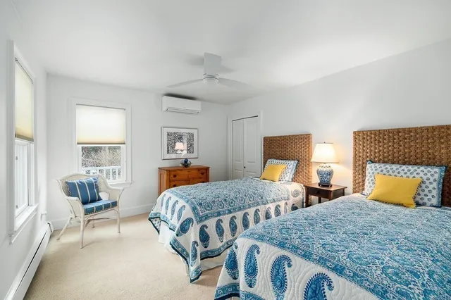 a bedroom with two beds and a couch