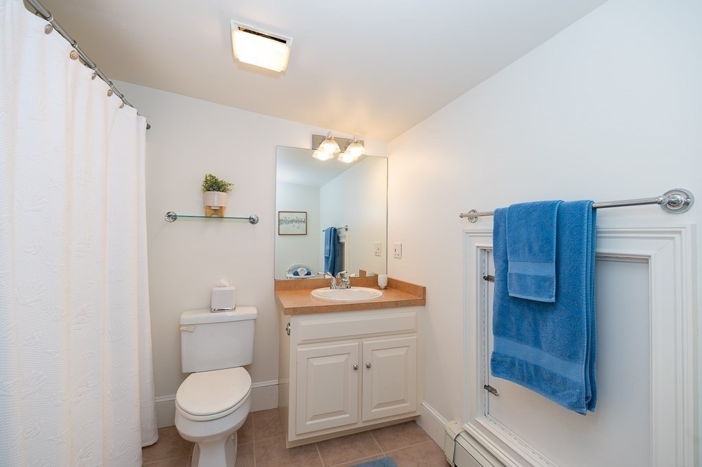 7 Hawthorne Lane Gloucester, MA 01930 - Photo 20 of 24 a bathroom with a toilet sink vanity and mirror