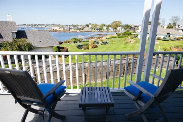 a view of a balcony with chair and wooden floor
