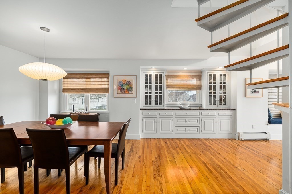 7 Hawthorne Lane Gloucester, MA 01930 - Photo 8 of 24 a kitchen with stainless steel appliances kitchen island granite countertop a dining table chairs and chandelier