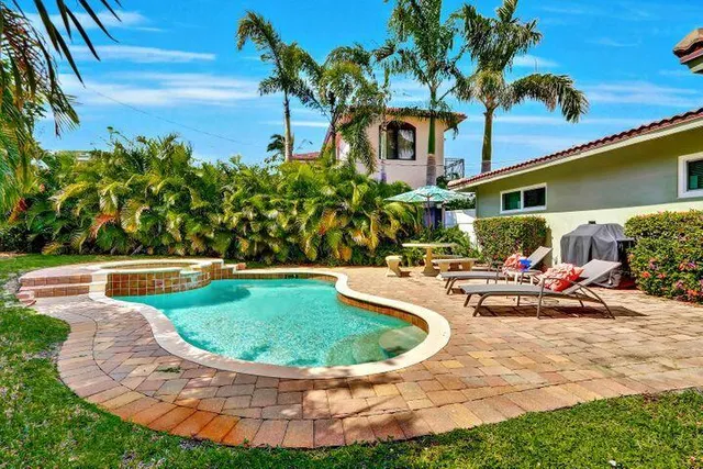 a view of a swimming pool with lounge chair