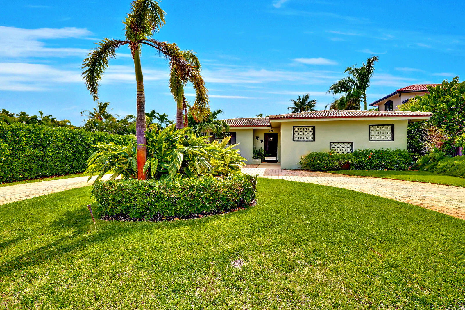 390 North Juno Lane Juno Beach, FL 33408 - Photo 13 of 33 a front view of a house with a garden
