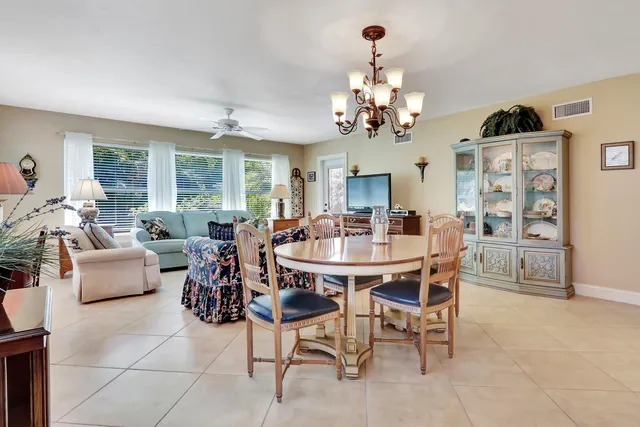 a view of a dining room with furniture and a chandelier