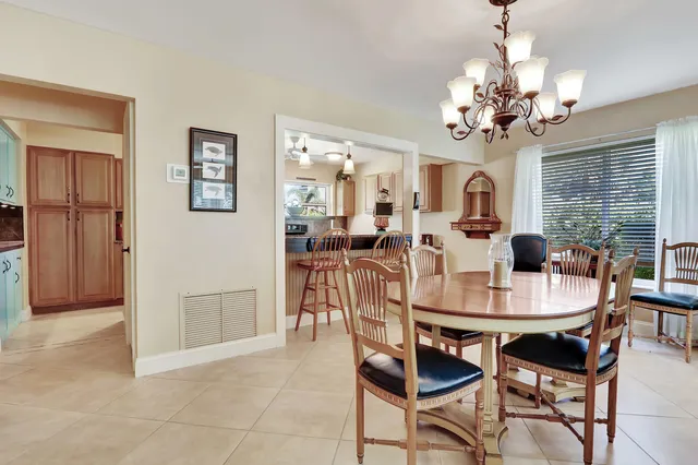 a view of a dining room with furniture and a chandelier