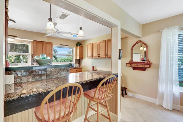 a kitchen with stainless steel appliances granite countertop a sink and a refrigerator