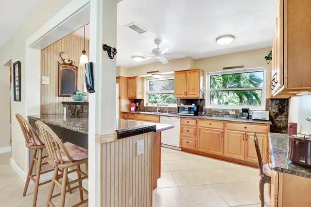 a kitchen with stainless steel appliances granite countertop a sink and cabinets