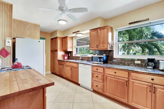a kitchen with granite countertop cabinets and window
