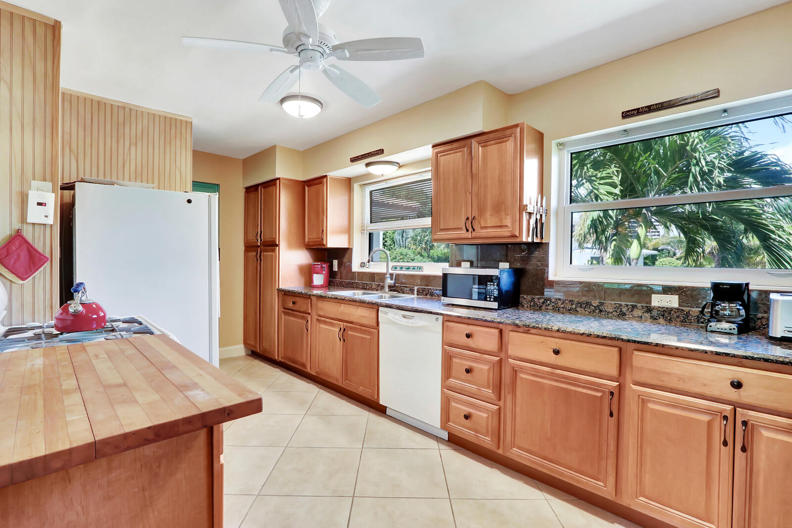 390 North Juno Lane Juno Beach, FL 33408 - Photo 23 of 33 a kitchen with granite countertop cabinets and window