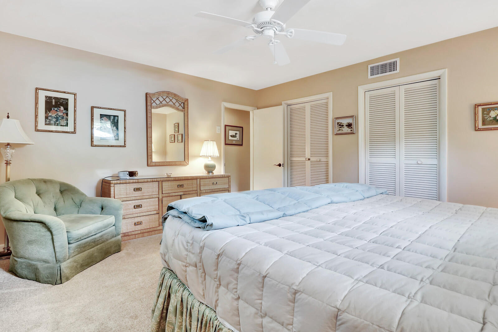 390 North Juno Lane Juno Beach, FL 33408 - Photo 28 of 33 a spacious bedroom with a bed a couch and dresser
