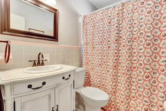 a bathroom with a sink toilet and mirror