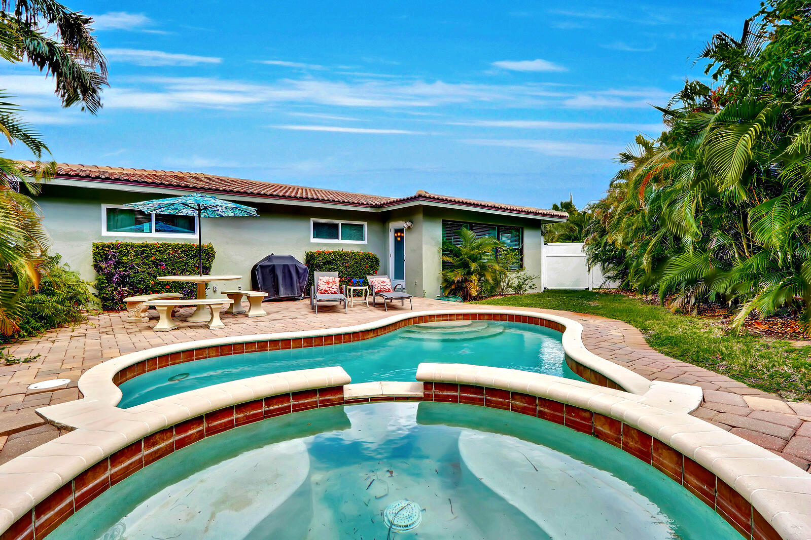 390 North Juno Lane Juno Beach, FL 33408 - Photo 7 of 33 a view of swimming pool with lawn chairs and plants
