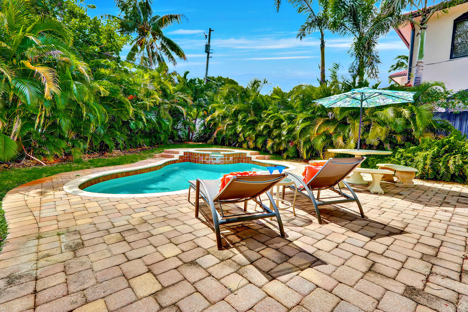 390 North Juno Lane Juno Beach, FL 33408 - Photo 8 of 33 a swimming pool with outdoor seating and plants