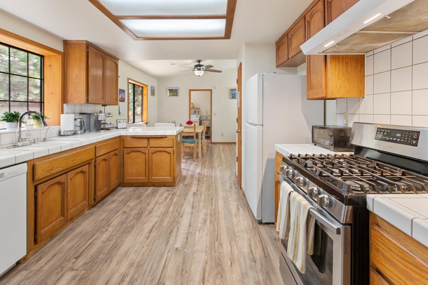 52865 Highway 245 Miramonte, CA 93641 - Photo 11 of 50 a kitchen with a sink stove and cabinets
