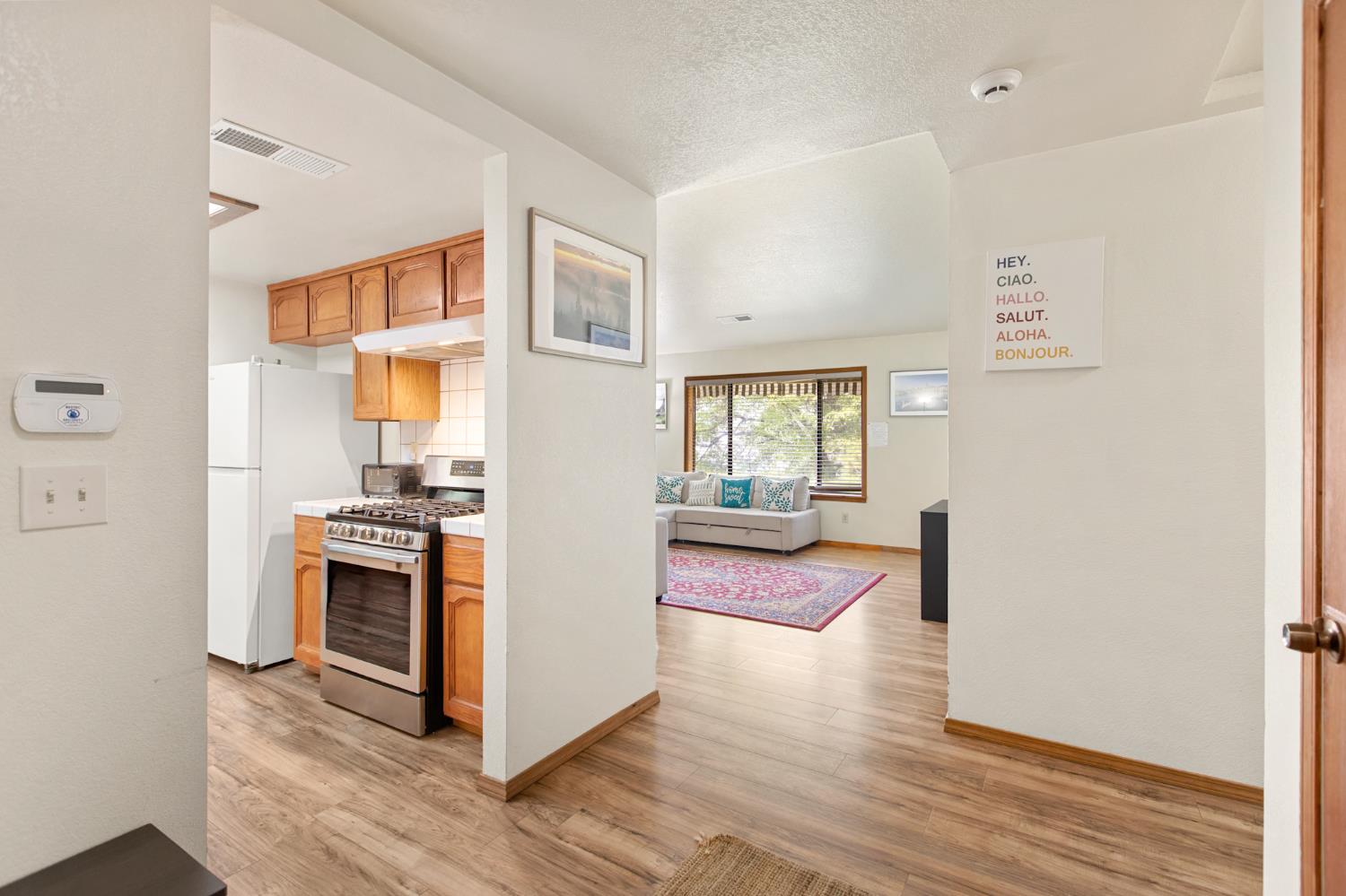 52865 Highway 245 Miramonte, CA 93641 - Photo 15 of 50 a kitchen with a refrigerator and wooden floor