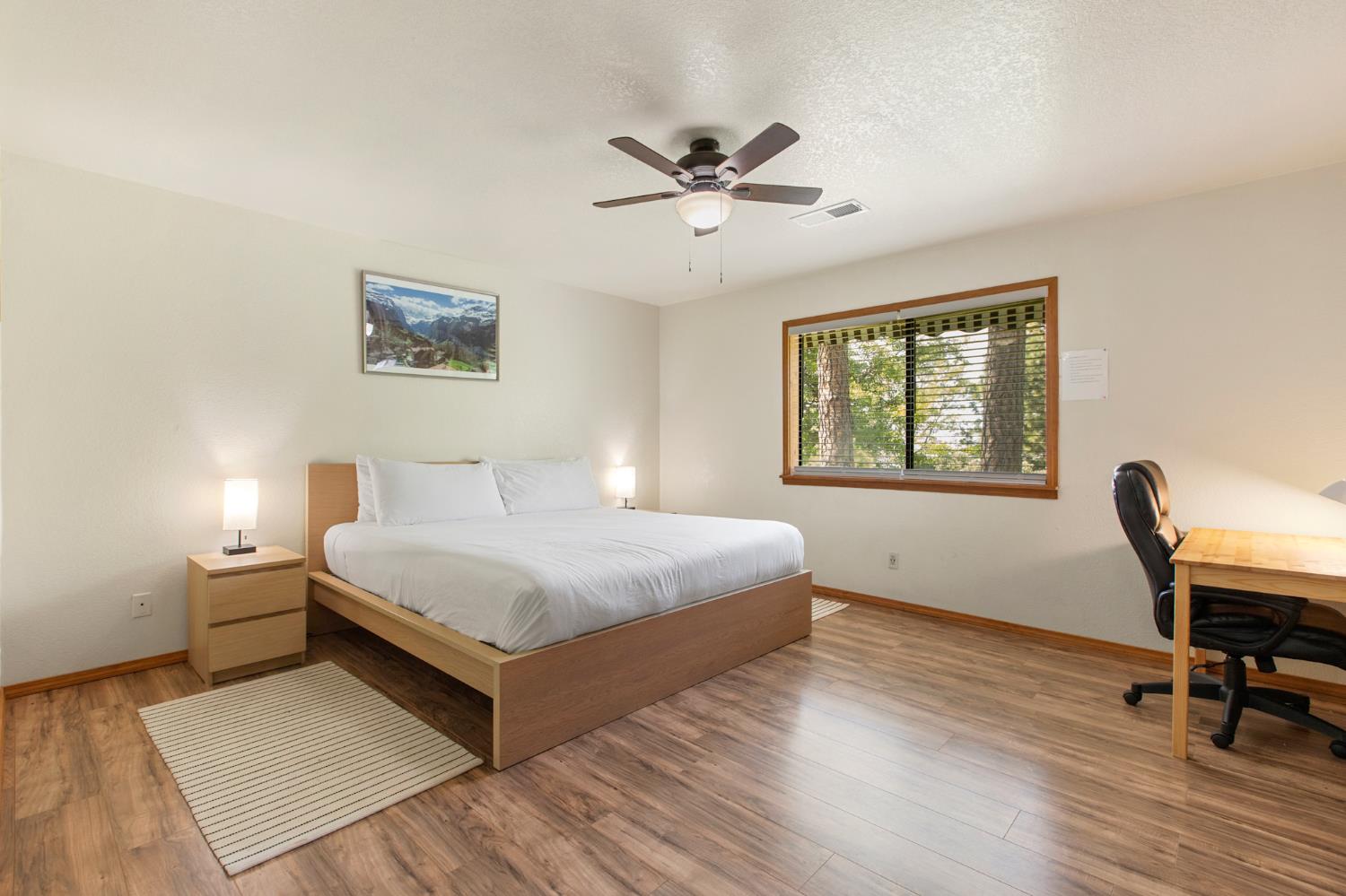 52865 Highway 245 Miramonte, CA 93641 - Photo 17 of 50 a bedroom with a bed and a desk