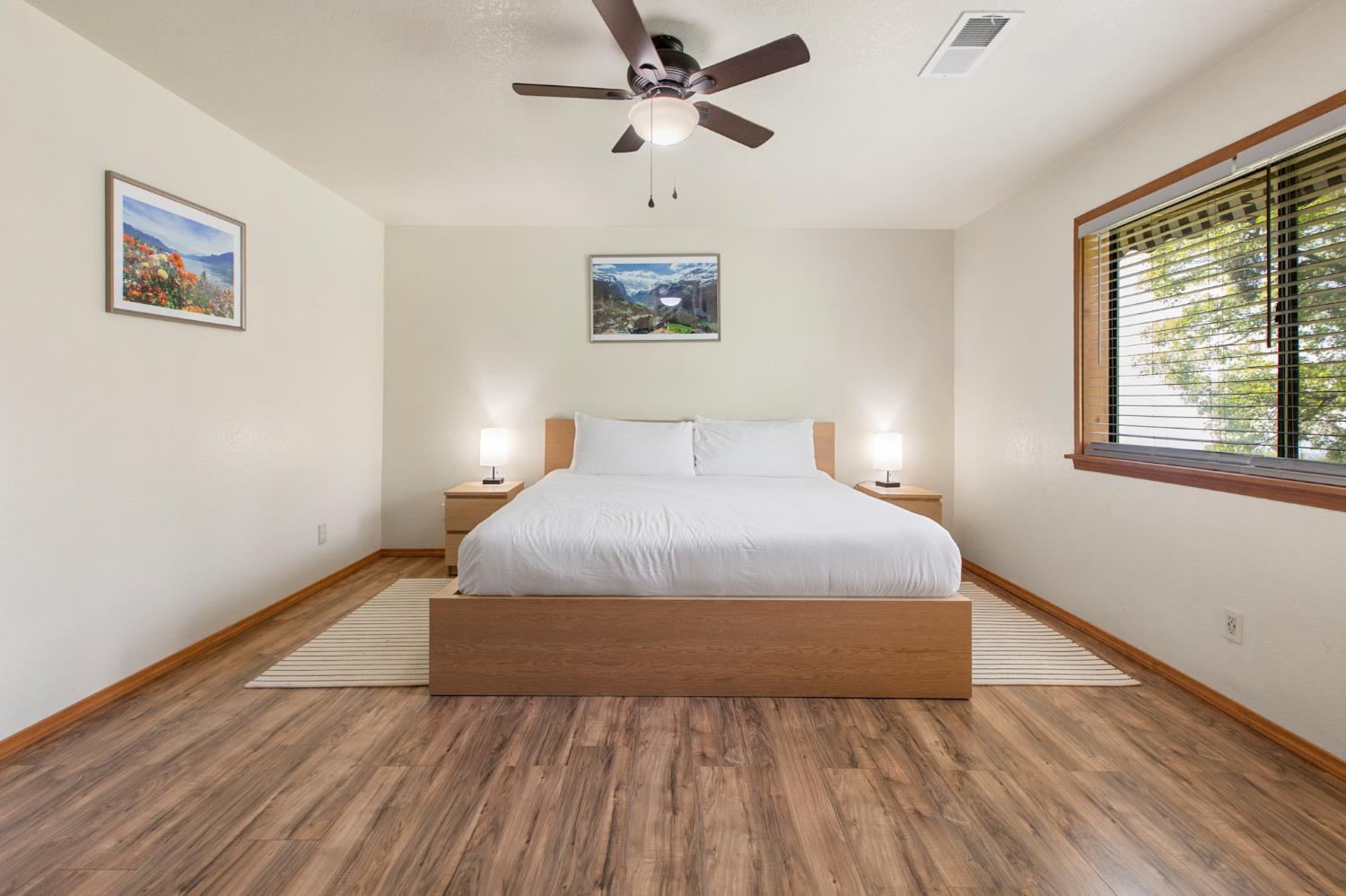 52865 Highway 245 Miramonte, CA 93641 - Photo 18 of 50 a bedroom with a large bed and a window