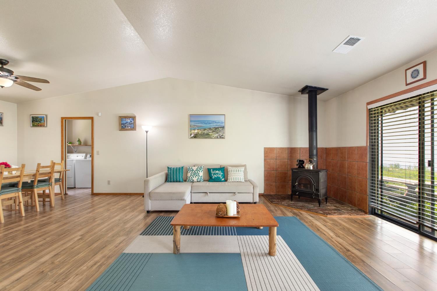52865 Highway 245 Miramonte, CA 93641 - Photo 7 of 50 a living room with furniture a large window wooden floor and a rug