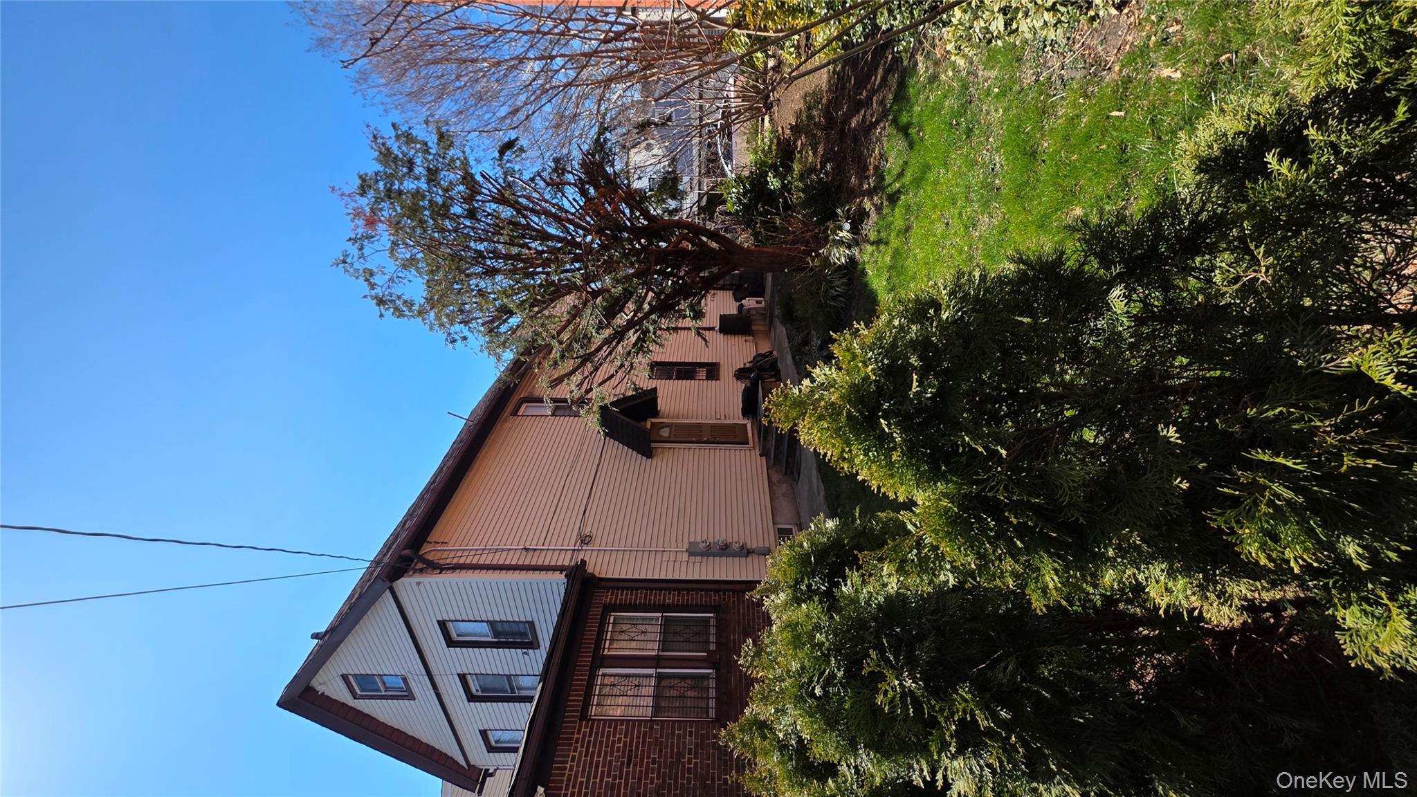 a backyard of a house with lots of plants and trees