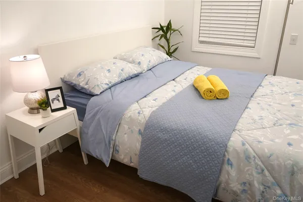 a bed sitting in a bedroom next to a window
