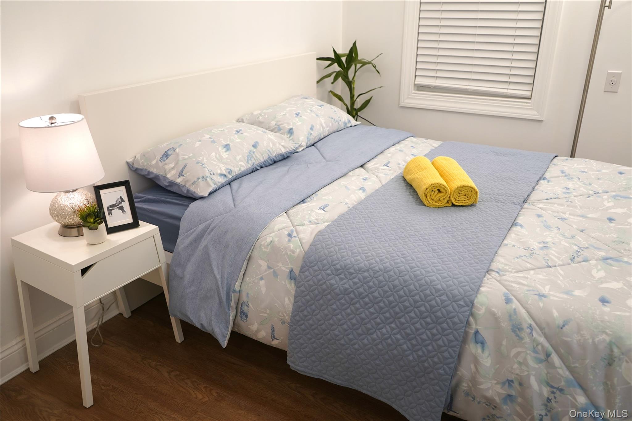 37-54 99th Street Queens, NY 11368 - Photo 12 of 18 a bed sitting in a bedroom next to a window