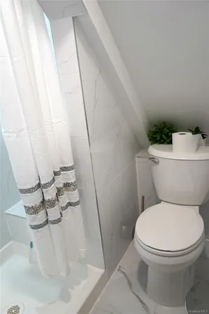 a white toilet sitting next to a sink