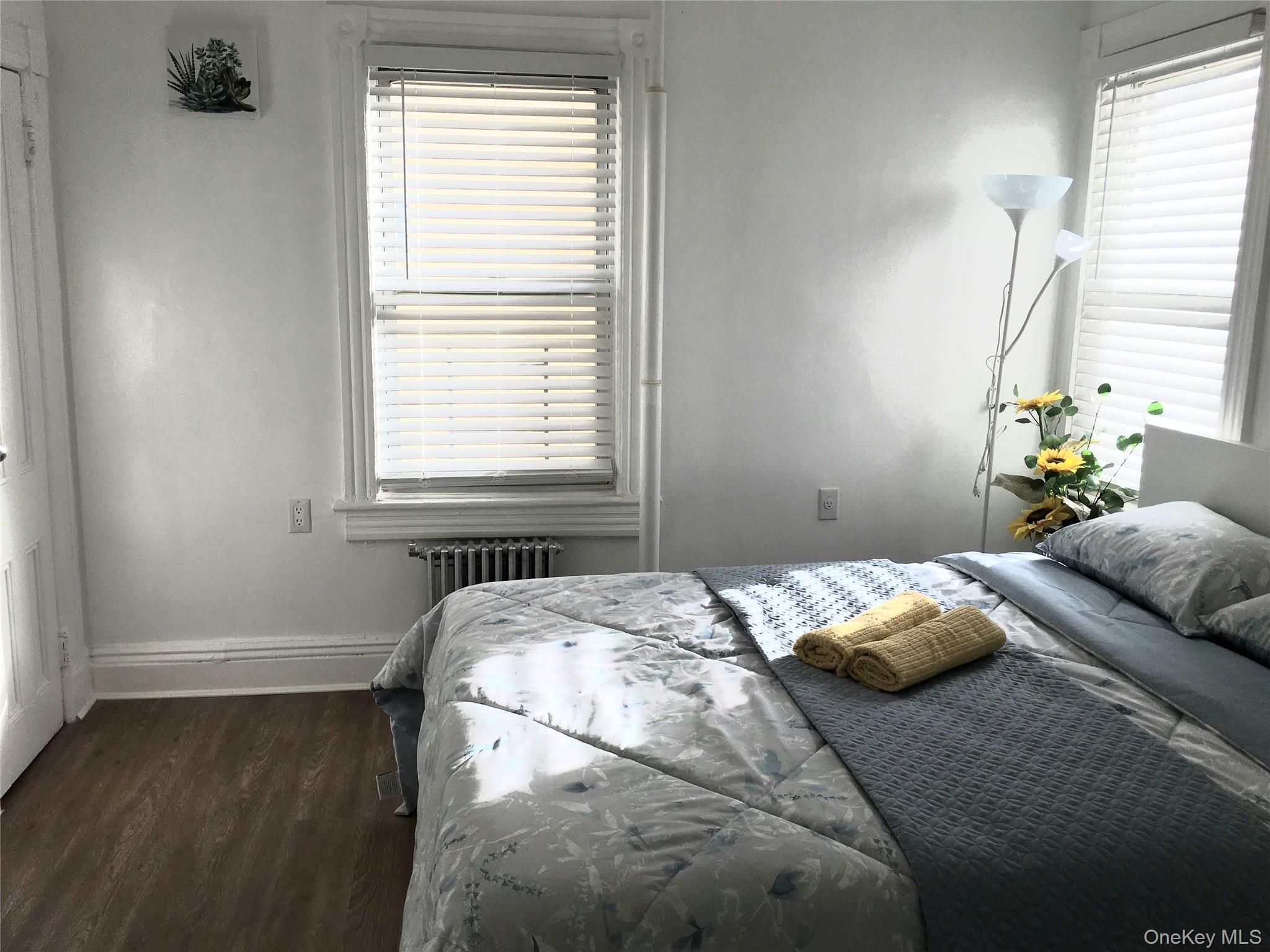 37-54 99th Street Queens, NY 11368 - Photo 3 of 18 a bedroom with a bed and a window