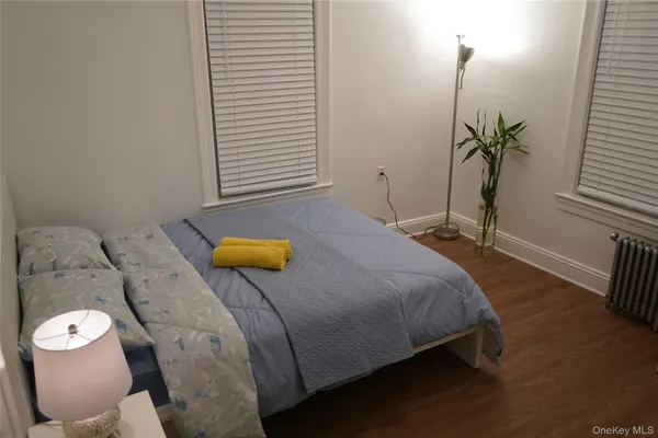 a bedroom with a bed and a window
