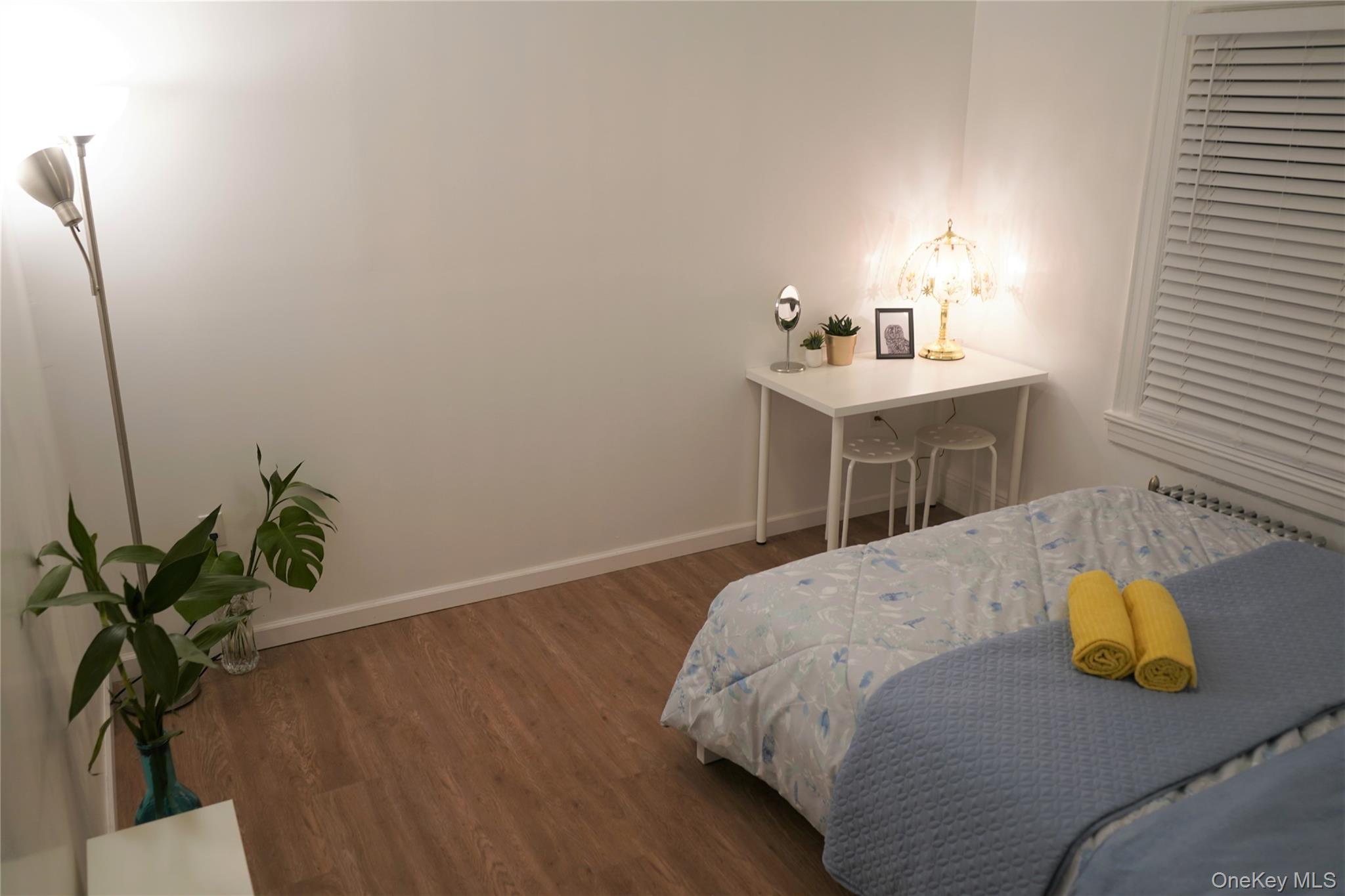 37-54 99th Street Queens, NY 11368 - Photo 5 of 18 a bedroom with a bed and a potted plant