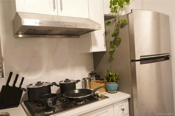 a kitchen with a stove and a refrigerator