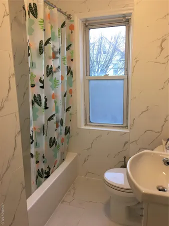 a bathroom with a bathtub and window