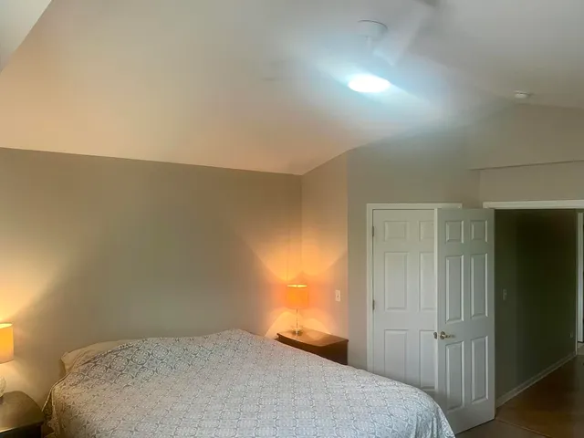 a bedroom with a bed and a night stand