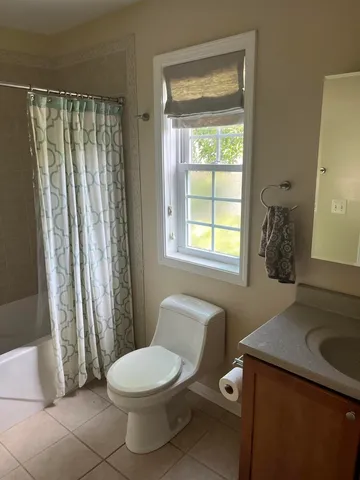 a bathroom with a toilet a sink and a shower
