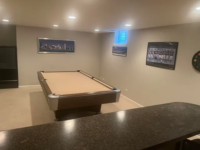 a room with pool table and couch