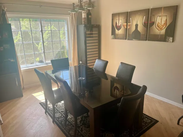 a view of a dining room with furniture and chandelier