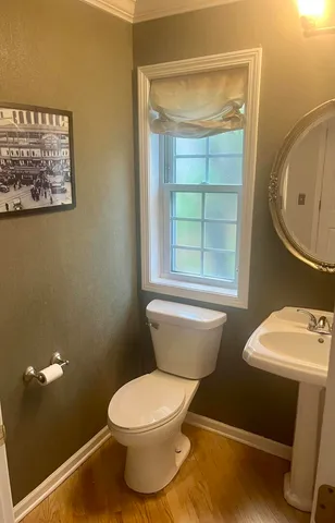 a bathroom with a toilet a sink and a window