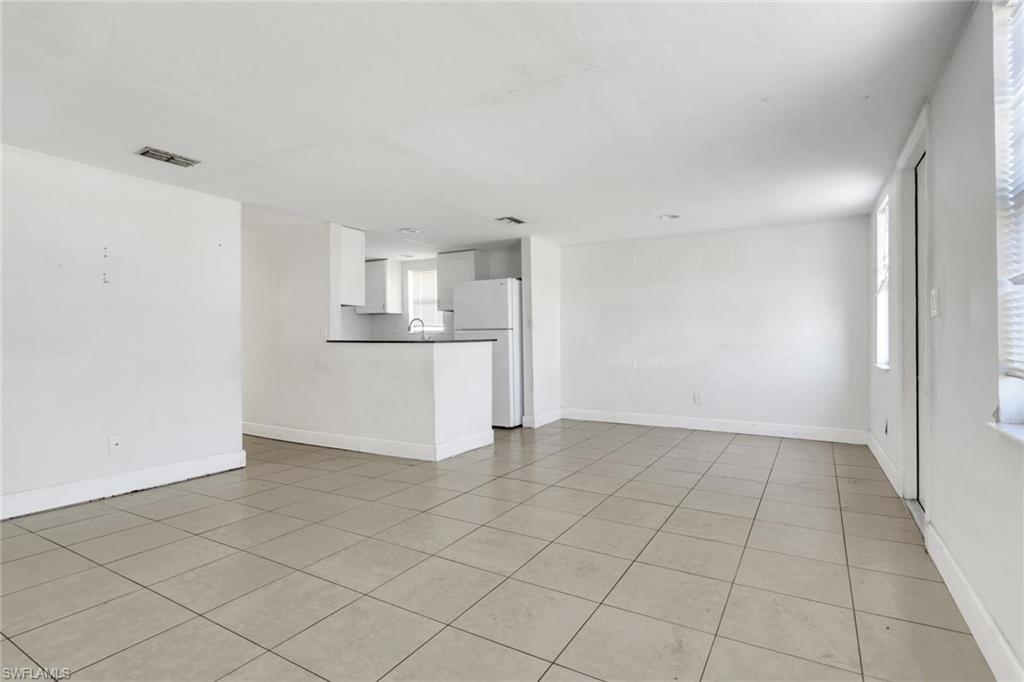 5326 Dixie Drive Naples, FL 34113 - Photo 11 of 25 a view of a kitchen with a sink and a refrigerator