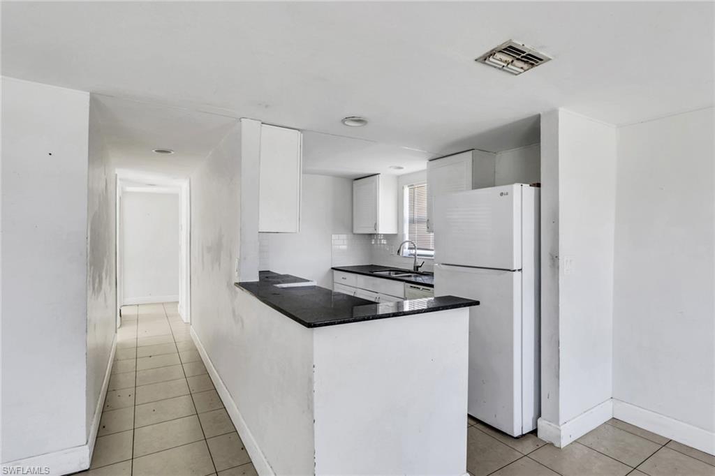 5326 Dixie Drive Naples, FL 34113 - Photo 4 of 25 a kitchen with a refrigerator and a sink