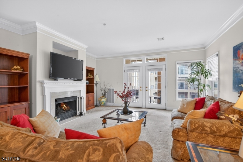 a living room with furniture flat screen tv and a fireplace