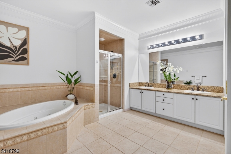 9210 Ravenscroft Road Clifton, NJ 07013 - Photo 15 of 18 a spacious bathroom with a granite countertop sink and a bathtub