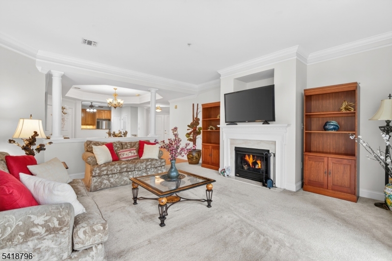 9210 Ravenscroft Road Clifton, NJ 07013 - Photo 6 of 18 a living room with furniture a fireplace and a flat screen tv