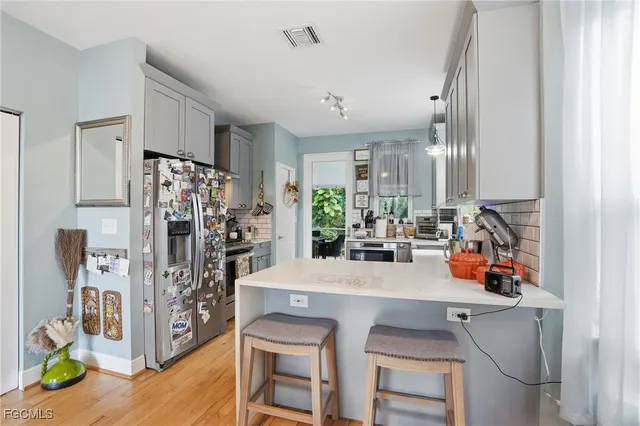 a view of a kitchen with dining table and chairs