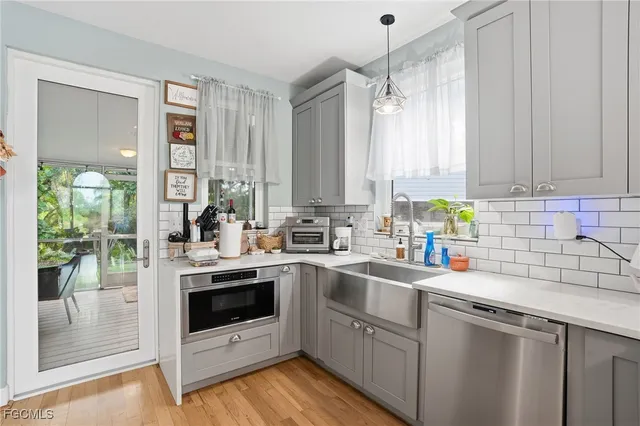 a kitchen with a sink stove and cabinets