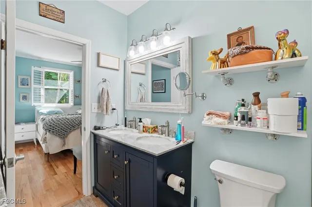a bathroom with a sink mirror and vanity