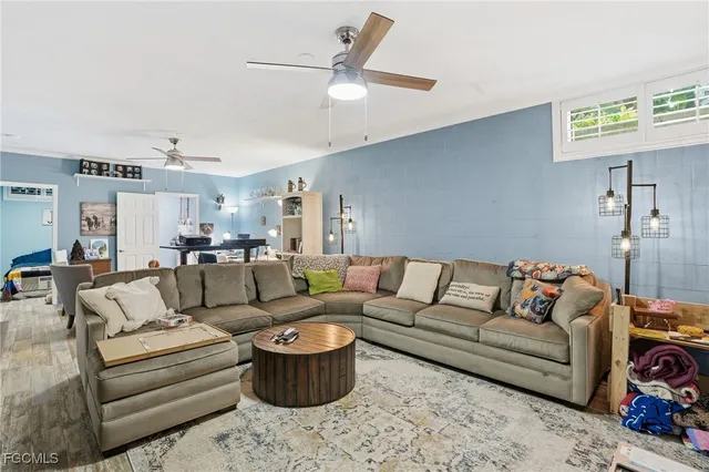 a living room with furniture or couch and a ceiling fan