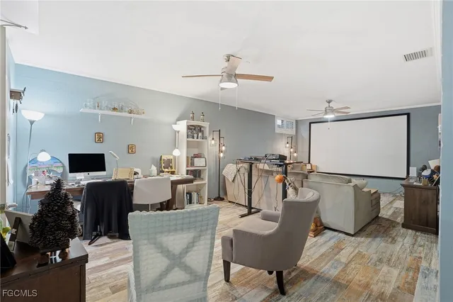 a living room with furniture a flat screen tv and a table