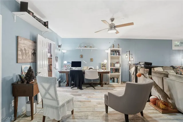 a living room with furniture kitchen view and a window