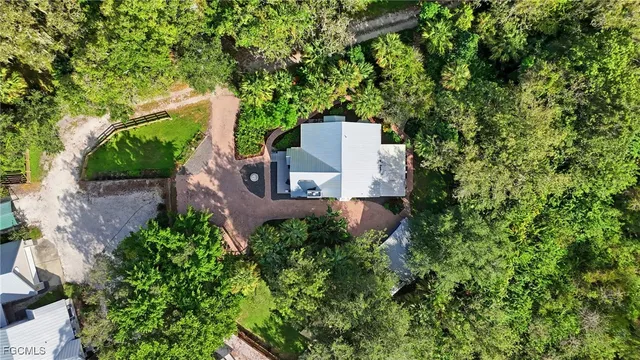 an aerial view of a house with a yard