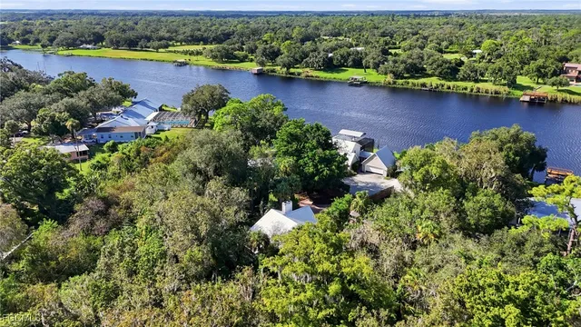 an aerial view of a houses with a lake view
