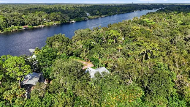 an aerial view of residential houses with outdoor space and lake view