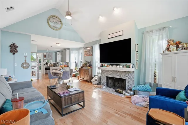 a living room with fireplace furniture and a flat screen tv